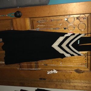 Black romper with lace detail.